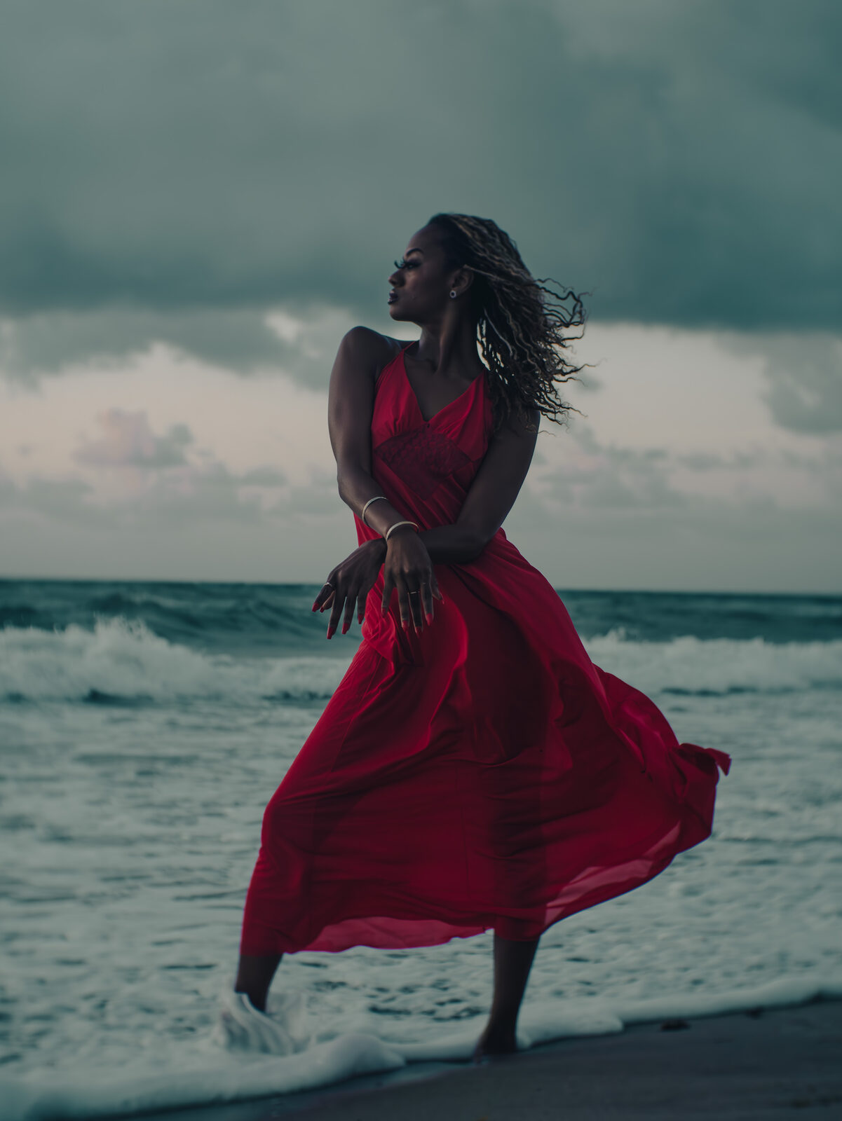 Portrait, red dress on the beach