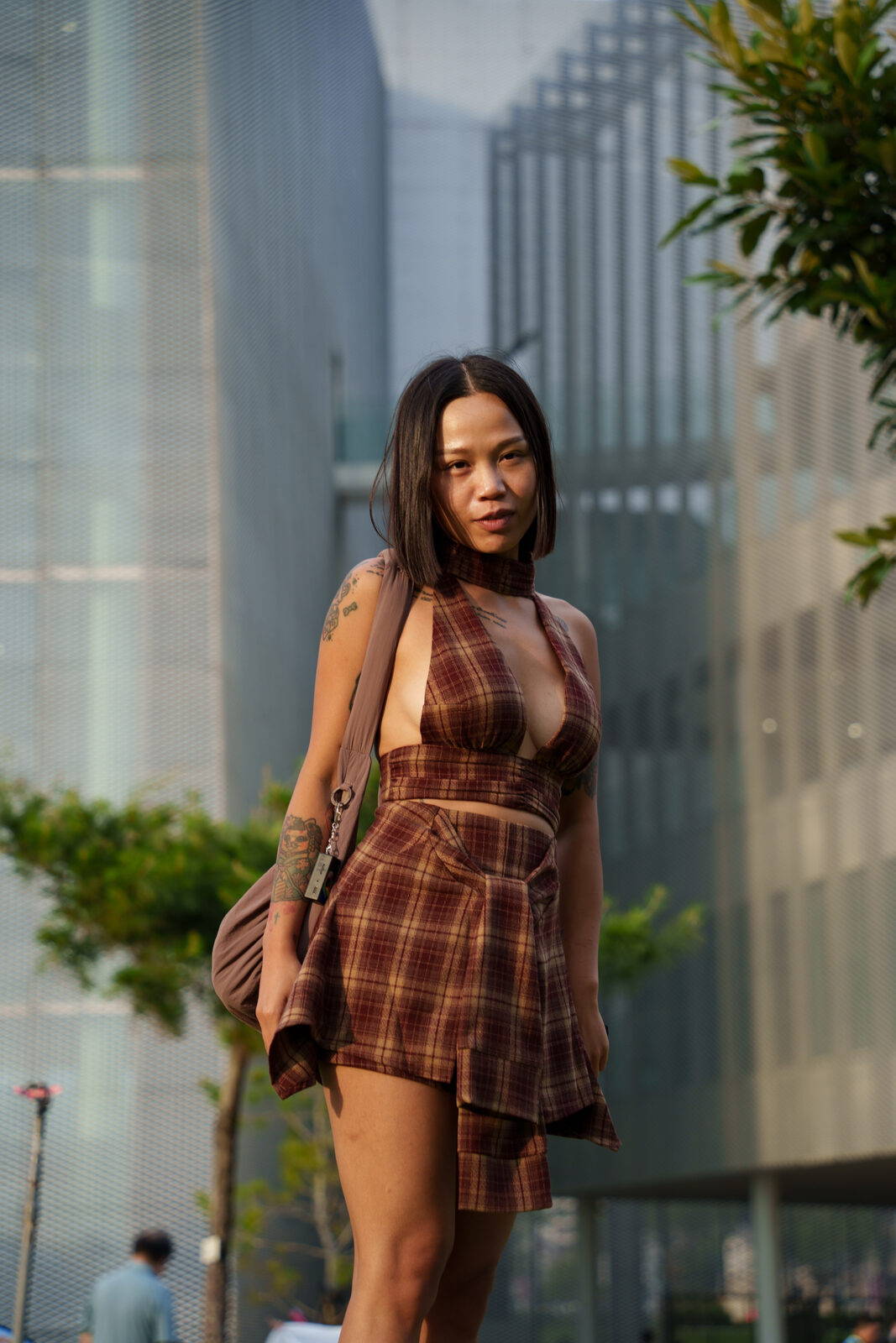 Portrait, plaid halter set against glass building