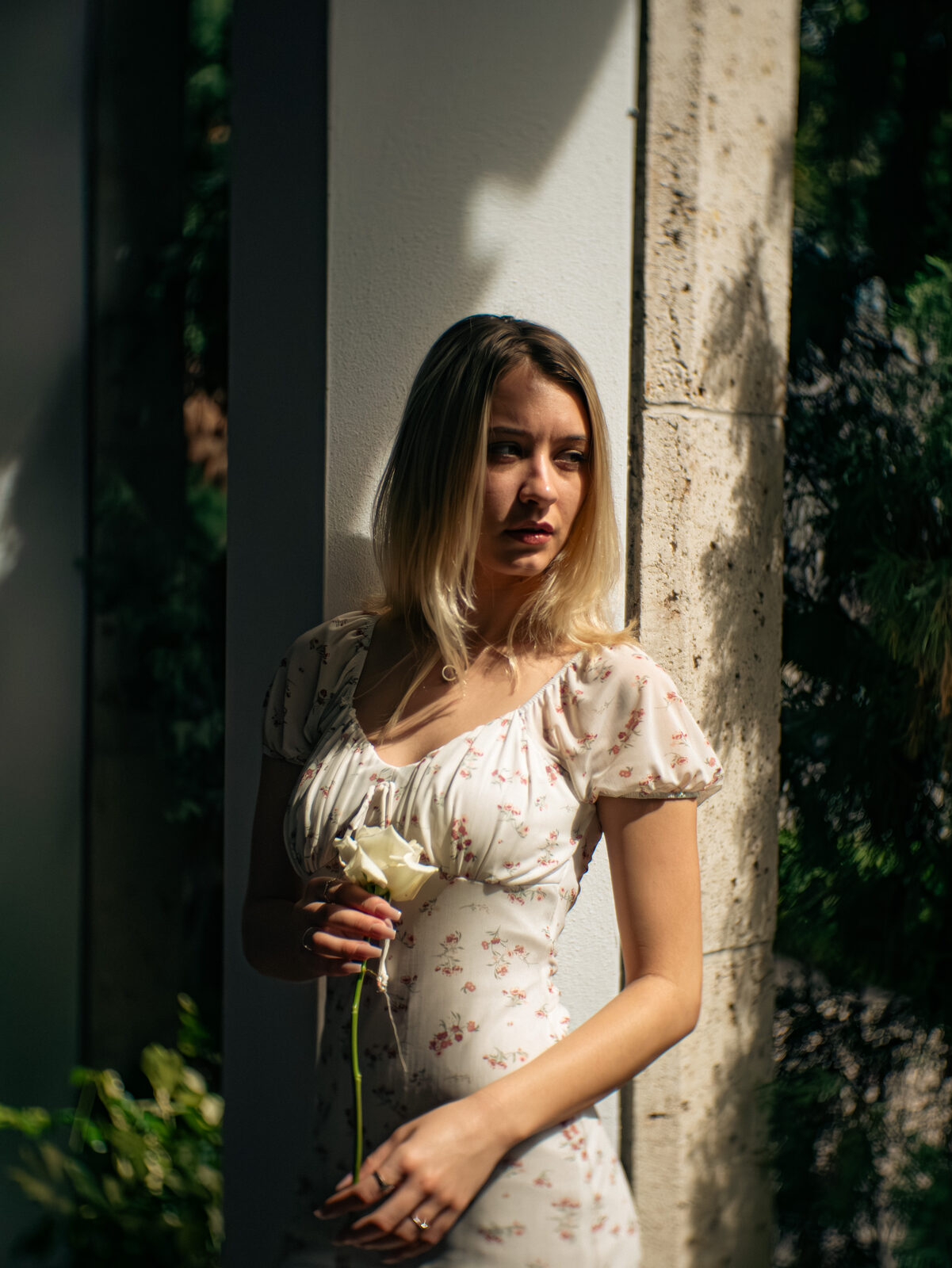 Portrait, floral dress in dappled shade